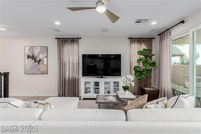 living area featuring baseboards, visible vents, recessed lighting, and ceiling fan