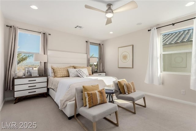 bedroom with visible vents, a ceiling fan, baseboards, and light carpet