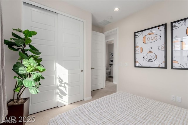 bedroom featuring recessed lighting, carpet, and a closet