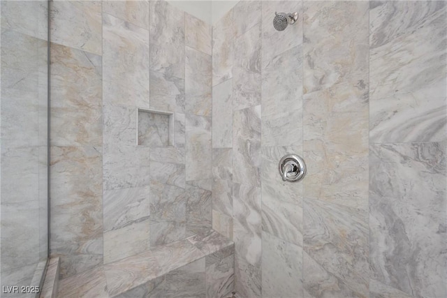 room details featuring a tile shower