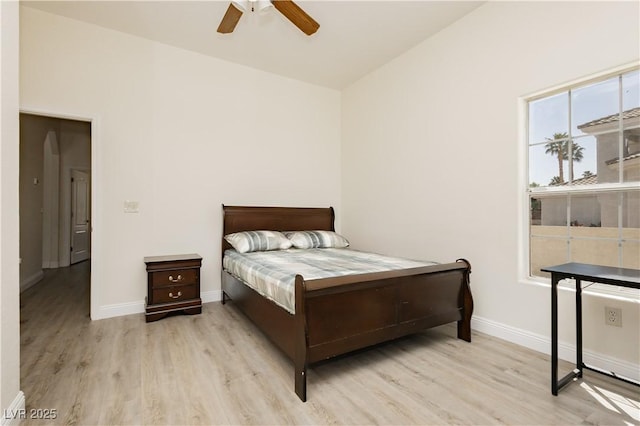 bedroom featuring baseboards, a ceiling fan, and wood finished floors