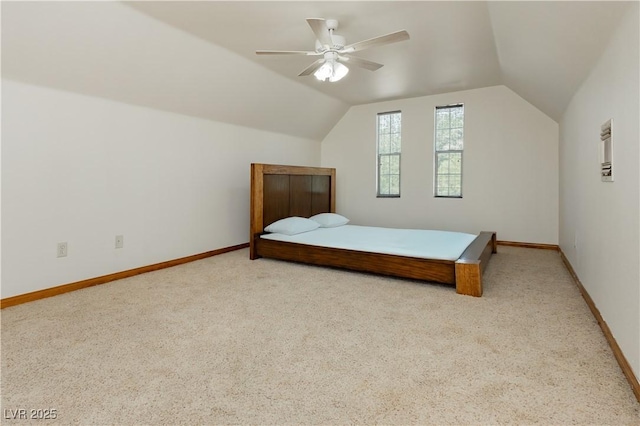 carpeted bedroom with baseboards, ceiling fan, and lofted ceiling