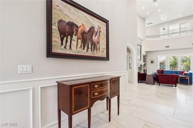 2338 Dolphin Ct, Henderson, NV 89074 - corridor featuring marble finish flooring, arched walkways, and a towering ceiling