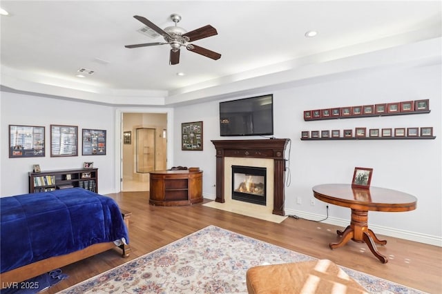 2338 Dolphin Ct, Henderson, NV 89074 - bedroom with wood finished floors, a fireplace with flush hearth, recessed lighting, a raised ceiling, and baseboards