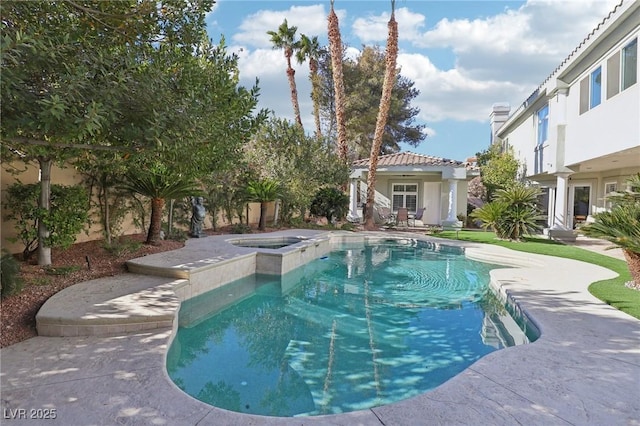 view of pool with a pool with connected hot tub and a patio