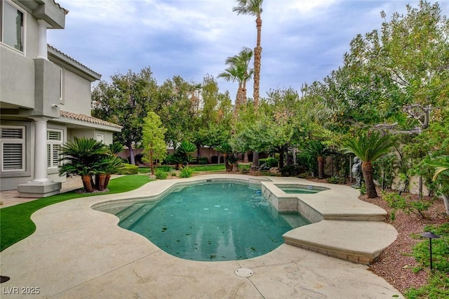 view of pool featuring a patio and a pool with connected hot tub