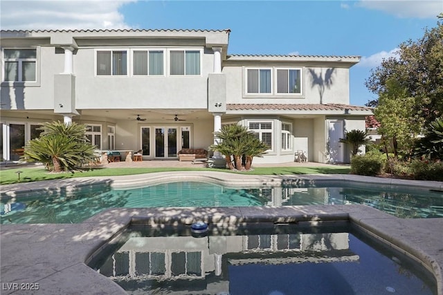 rear view of property featuring ceiling fan, stucco siding, a patio, a tile roof, and french doors