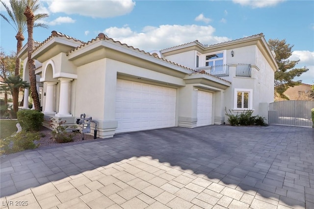 2338 Dolphin Ct, Henderson, NV 89074 - mediterranean / spanish home with a balcony, a garage, decorative driveway, and stucco siding