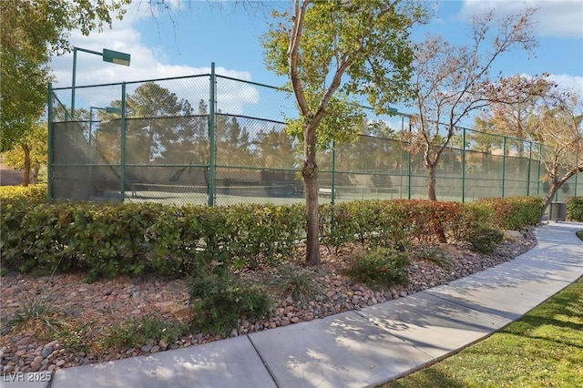 view of sport court featuring fence
