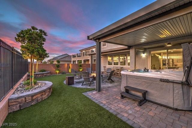 view of yard featuring a patio area, a fenced backyard, and a hot tub