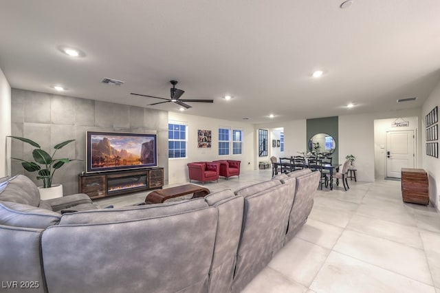 living room featuring light tile patterned floors, a ceiling fan, visible vents, and recessed lighting