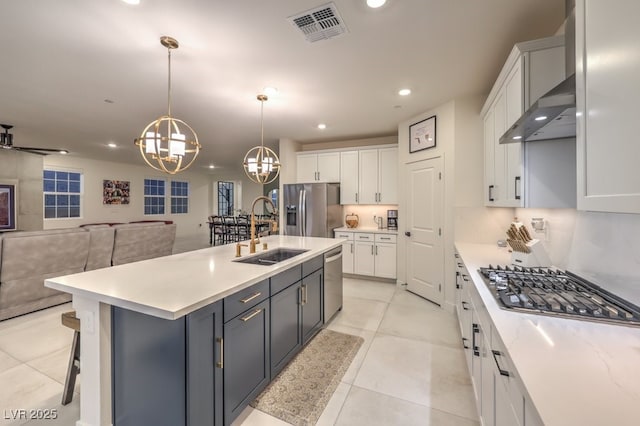 kitchen with visible vents, an inviting chandelier, a sink, appliances with stainless steel finishes, and white cabinetry
