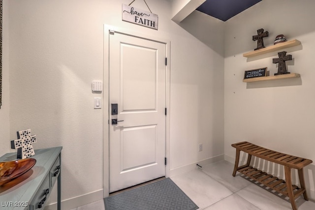 doorway featuring baseboards