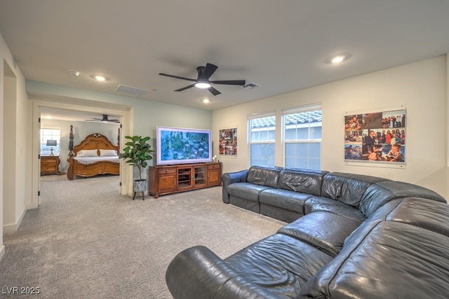carpeted living area featuring a ceiling fan, visible vents, and recessed lighting