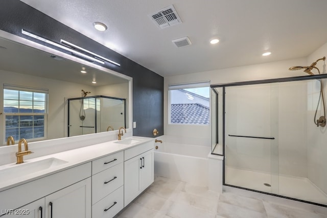 bathroom featuring a sink, visible vents, a shower stall, and a garden tub