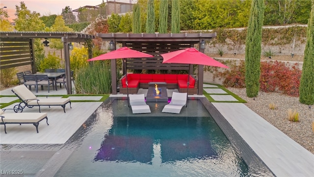 pool at dusk with an outdoor living space with a fire pit, outdoor dining space, a patio area, and an outdoor pool