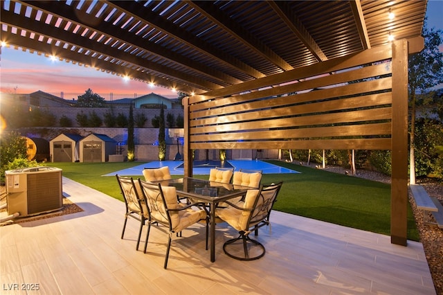 view of patio / terrace featuring a storage unit, a pergola, an outbuilding, outdoor dining area, and cooling unit
