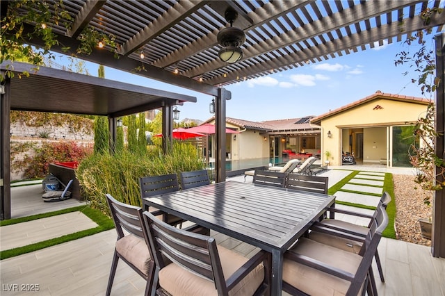 view of patio with a pergola, a ceiling fan, and outdoor dining space