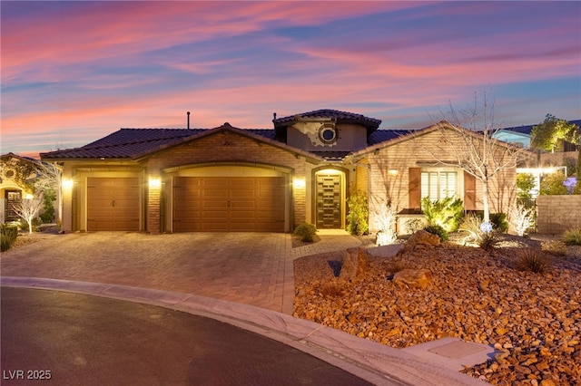 mediterranean / spanish home featuring driveway and a garage