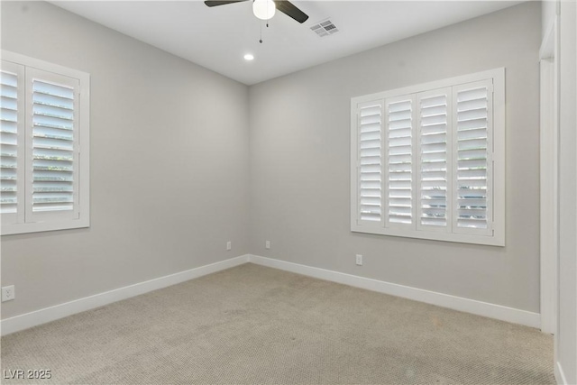 spare room featuring baseboards, ceiling fan, carpet, and visible vents