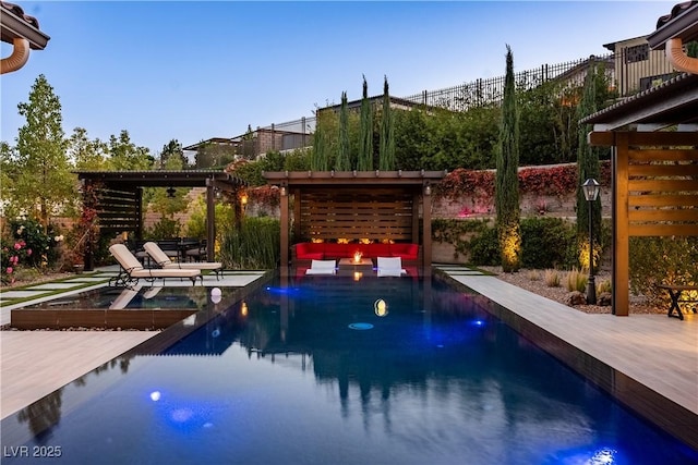 outdoor pool featuring a deck, fence, and a fire pit