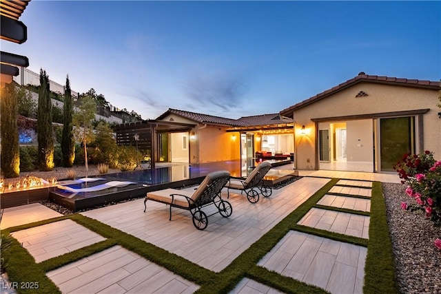 back of property with a patio, an outdoor pool, a tile roof, and stucco siding