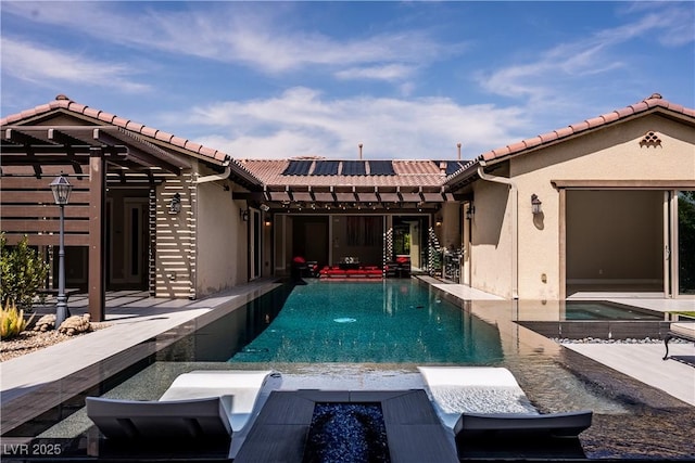 12119 Castilla Rain Ave, Las Vegas, NV 89138 - rear view of property featuring roof mounted solar panels, a tile roof, stucco siding, and an outdoor pool