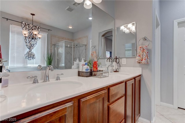 bathroom featuring a sink, tile patterned floors, a stall shower, double vanity, and visible vents