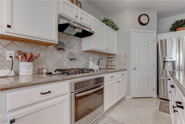 kitchen featuring light stone counters, appliances with stainless steel finishes, under cabinet range hood, and white cabinetry
