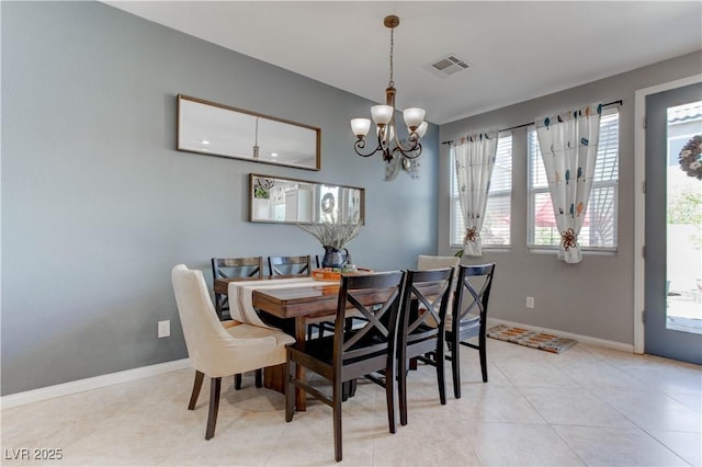 dining room featuring a notable chandelier, visible vents, and baseboards