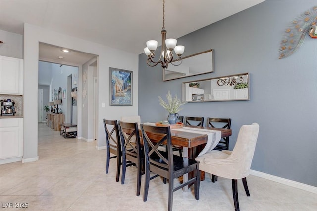 dining space with a notable chandelier and baseboards