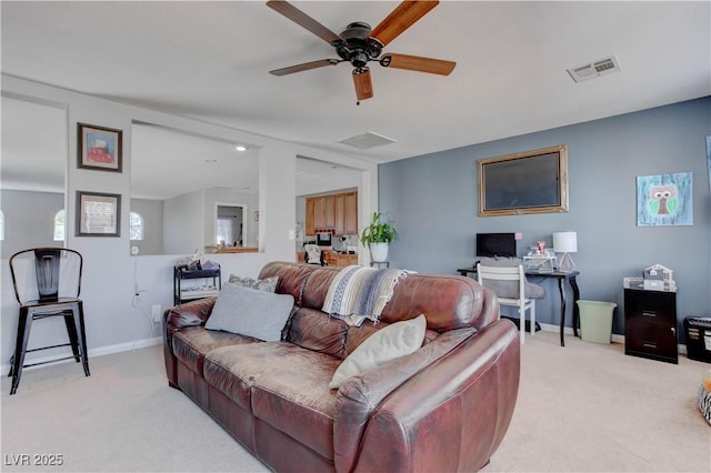 living area featuring visible vents, ceiling fan, and light carpet