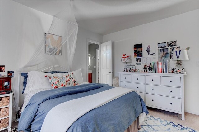 bedroom featuring baseboards and light carpet