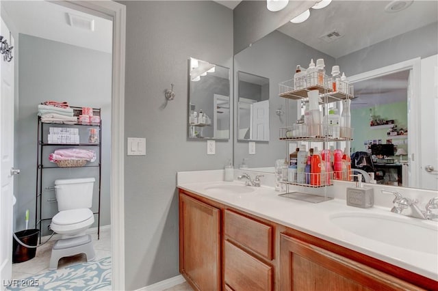full bathroom with double vanity, visible vents, toilet, and a sink