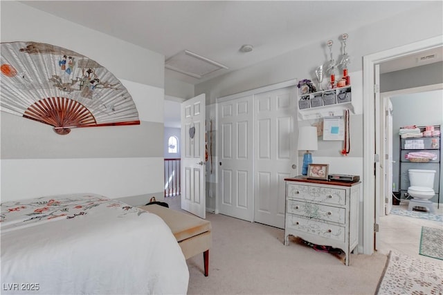 bedroom with attic access, a closet, visible vents, and carpet