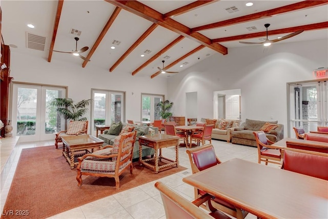 living area with visible vents, light tile patterned floors, a ceiling fan, and beamed ceiling