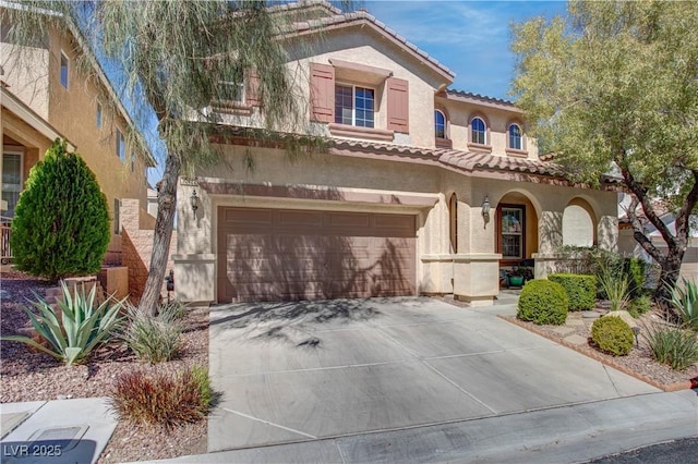 mediterranean / spanish-style home with a porch, stucco siding, a tiled roof, concrete driveway, and an attached garage
