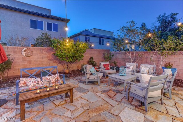 view of patio featuring outdoor lounge area and fence