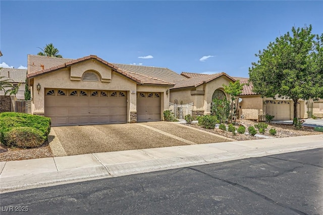 521 Dawn Cove Dr, Henderson, NV 89052 - view of front of house featuring stucco siding, asphalt driveway, a garage, and a tiled roof