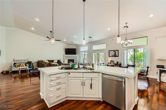 521 Dawn Cove Dr, Henderson, NV 89052 - kitchen featuring stainless steel dishwasher, open floor plan, light countertops, crown molding, and healthy amount of natural light