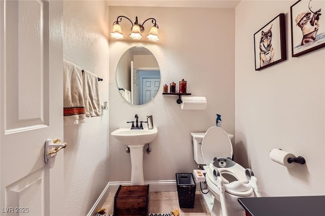 521 Dawn Cove Dr, Henderson, NV 89052 - half bathroom featuring toilet, baseboards, and tile patterned floors
