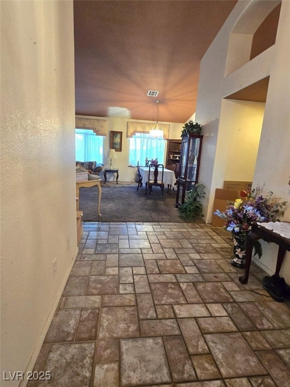 interior space with visible vents and brick floor