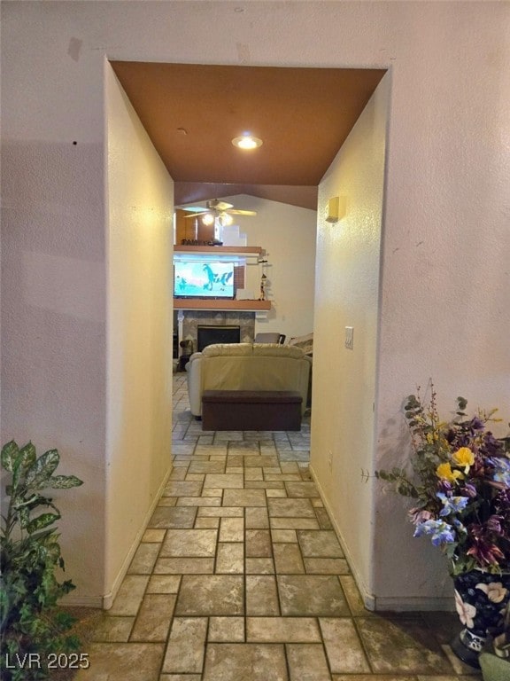 hallway with baseboards and brick floor