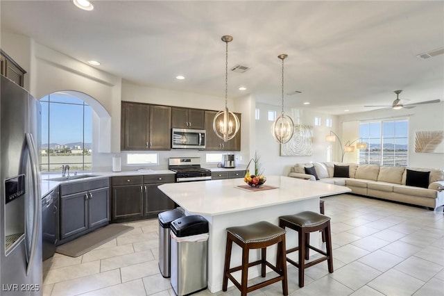 kitchen featuring light tile patterned floors, appliances with stainless steel finishes, light countertops, a sink, and visible vents