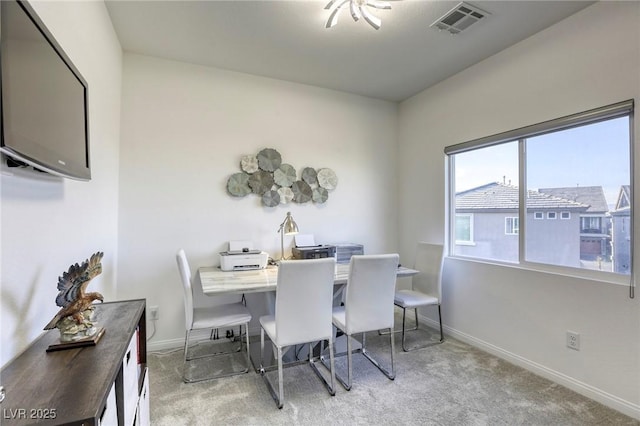 carpeted dining area featuring baseboards and visible vents