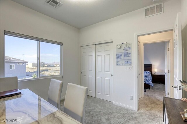 office featuring light colored carpet, visible vents, and baseboards