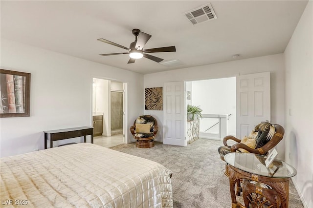 bedroom featuring visible vents, a ceiling fan, light carpet, and ensuite bathroom