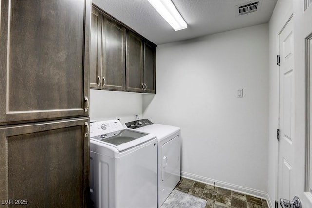 washroom with cabinet space, baseboards, independent washer and dryer, and visible vents