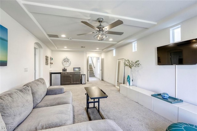living room with visible vents, recessed lighting, light carpet, a ceiling fan, and stairs