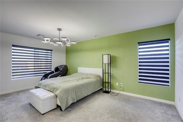 carpeted bedroom featuring a chandelier, baseboards, and visible vents